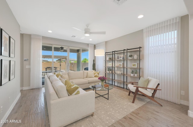 18746 W Rancho Dr, Litchfield Park, AZ 85340 - living room with wood finished floors, ceiling fan, visible vents, and baseboards