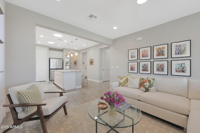 18746 W Rancho Dr, Litchfield Park, AZ 85340 - living room featuring visible vents, recessed lighting, baseboards, and light wood-style floors