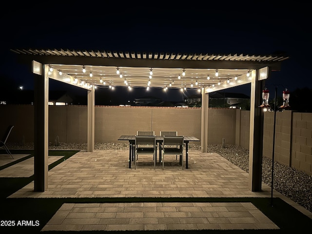 18746 W Rancho Dr, Litchfield Park, AZ 85340 - patio at twilight with a pergola, outdoor dining area, and a fenced backyard