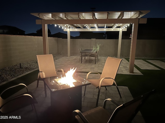 18746 W Rancho Dr, Litchfield Park, AZ 85340 - patio at twilight with a pergola, a fire pit, and a fenced backyard