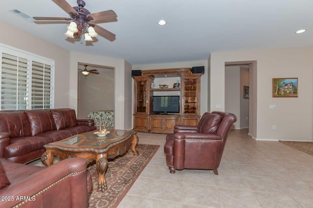 living room featuring light tile patterned flooring and ceiling fan