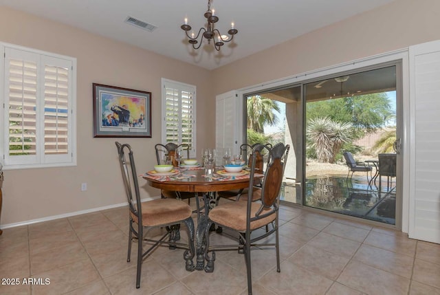 dining area with a notable chandelier and light tile patterned floors