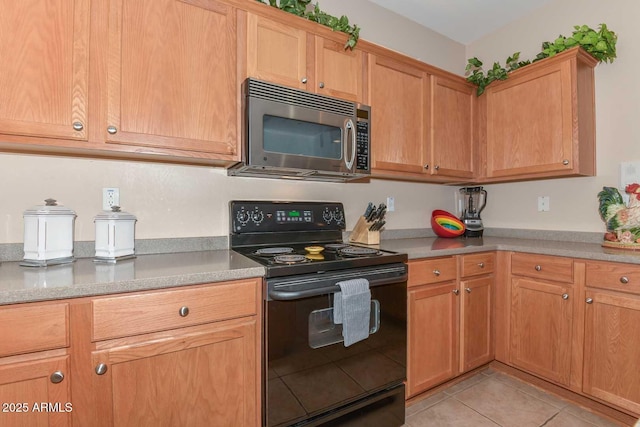 kitchen featuring black / electric stove and light tile patterned floors