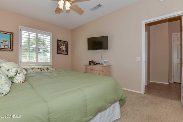 bedroom with vaulted ceiling, light tile patterned floors, and ceiling fan