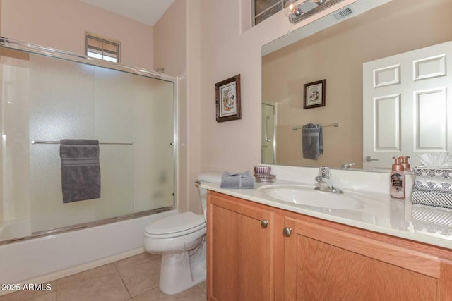 full bathroom with vanity, tile patterned floors, toilet, and combined bath / shower with glass door