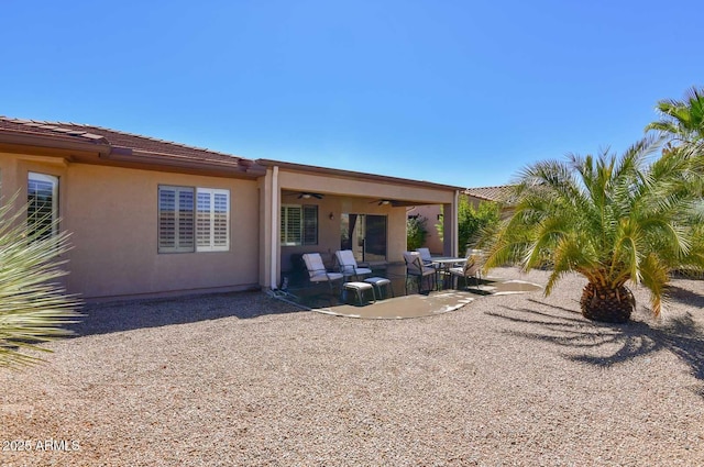 rear view of house with a patio and ceiling fan