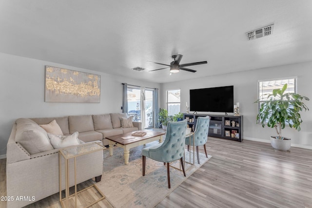 living room featuring ceiling fan and hardwood / wood-style floors