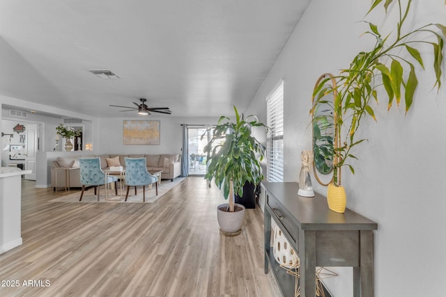 living room featuring ceiling fan and light wood-type flooring