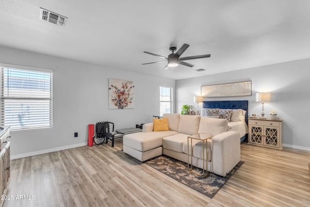 living room featuring ceiling fan and light hardwood / wood-style floors