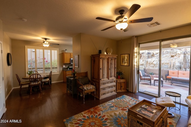 living room featuring a wealth of natural light, dark wood-type flooring, and ceiling fan