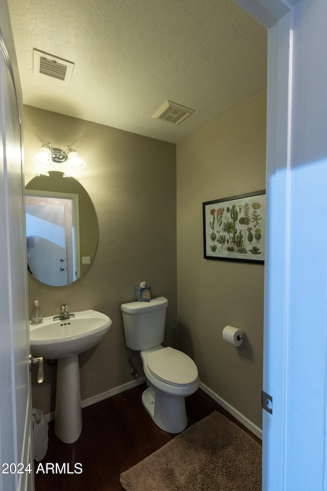 bathroom featuring hardwood / wood-style floors, toilet, and sink