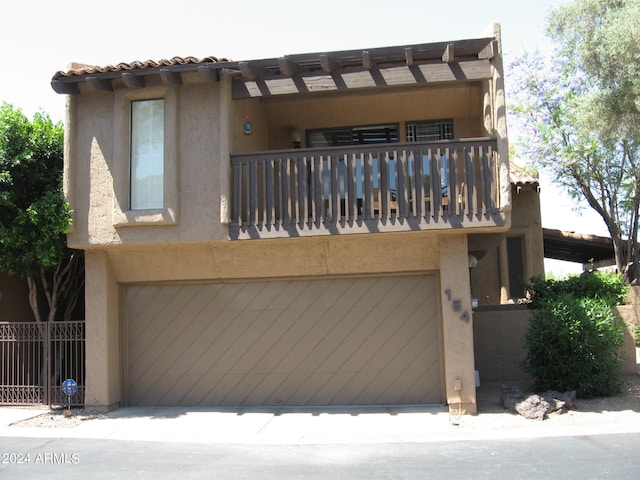 view of front facade with a balcony and a garage