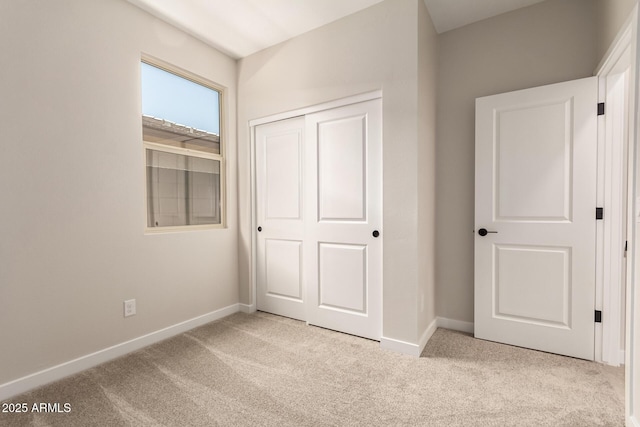 5641 N 205th Ln, Buckeye, AZ 85396 - unfurnished bedroom with carpet floors, baseboards, and a closet