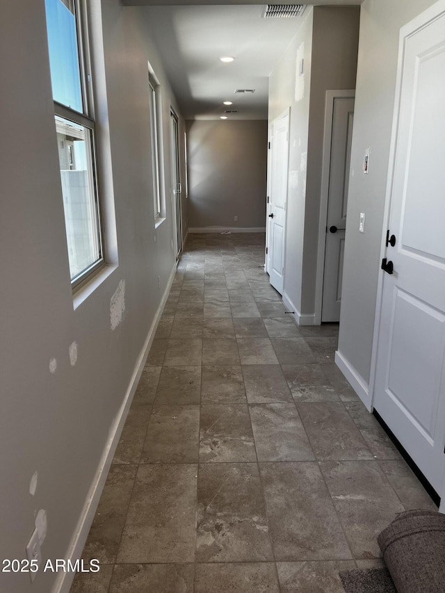 5641 N 205th Ln, Buckeye, AZ 85396 - hallway featuring baseboards and dark stone finish flooring