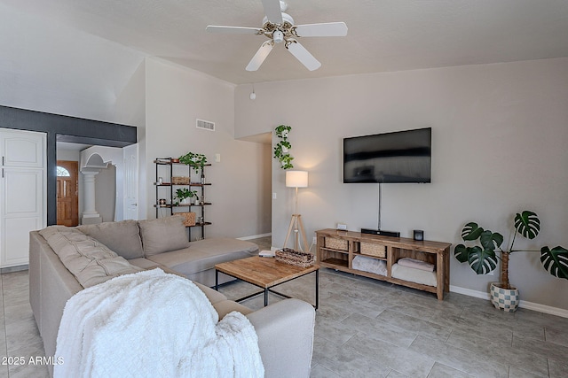 living area with baseboards, a ceiling fan, visible vents, and lofted ceiling