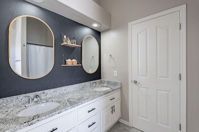 full bathroom featuring tile patterned flooring, a sink, and double vanity