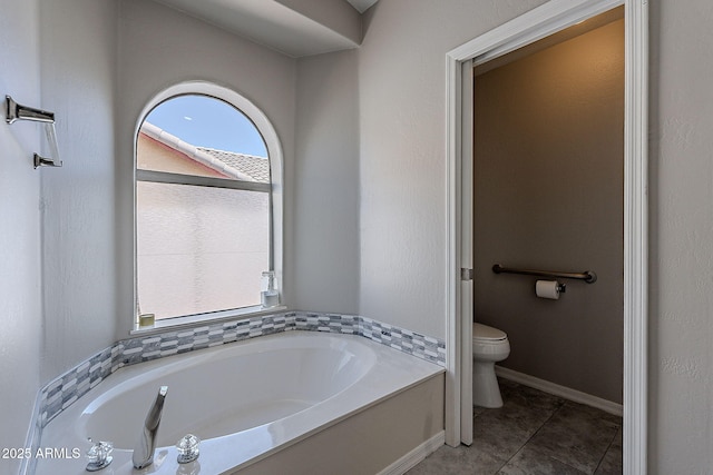 bathroom with a bath, toilet, and tile patterned floors