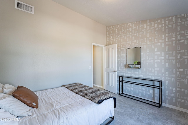 bedroom with baseboards, visible vents, tile patterned flooring, and wallpapered walls