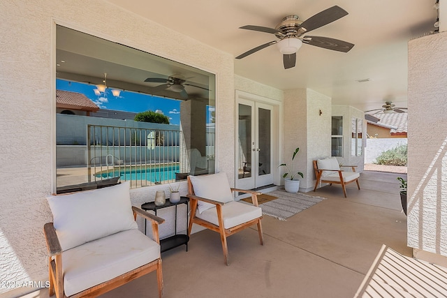 view of patio with fence, a fenced in pool, ceiling fan, and french doors