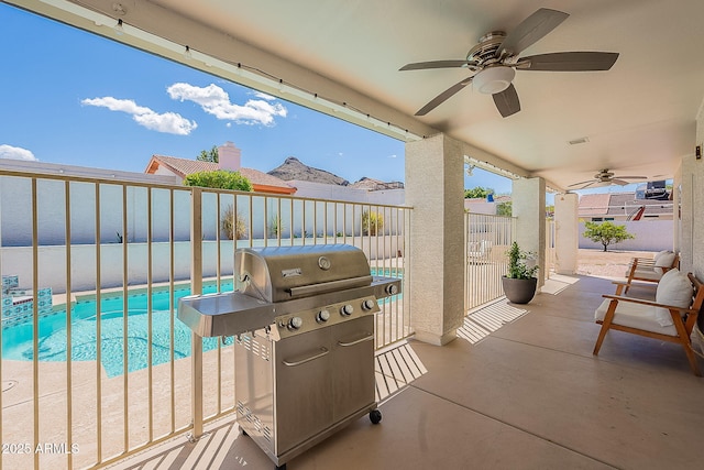 view of patio featuring a fenced backyard, a grill, an outdoor pool, and ceiling fan
