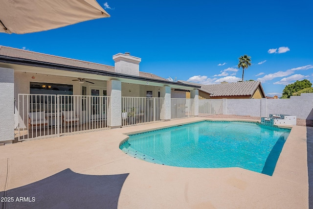 view of swimming pool featuring fence, a ceiling fan, a patio, and a fenced in pool