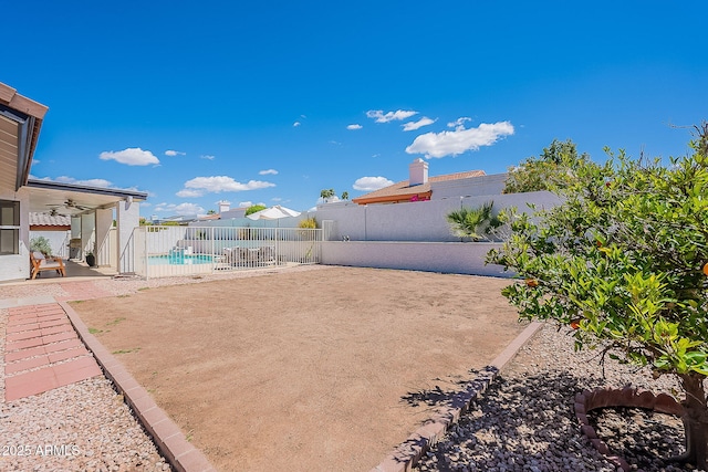view of yard with a fenced backyard, a fenced in pool, a patio, and ceiling fan