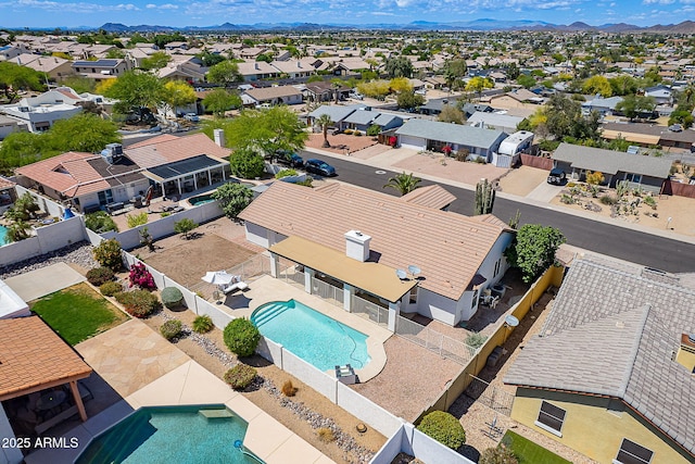 birds eye view of property with a mountain view and a residential view