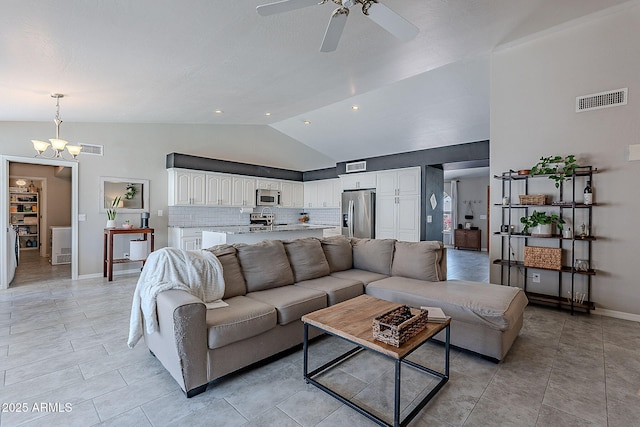 living room featuring vaulted ceiling, visible vents, baseboards, and ceiling fan with notable chandelier