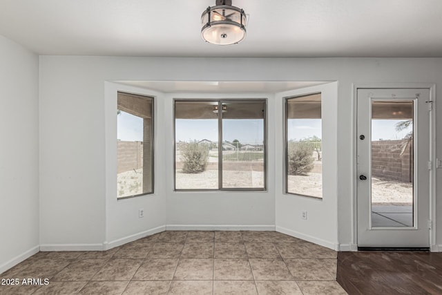 23637 N Desert Dr, Florence, AZ 85132 - unfurnished room featuring plenty of natural light, light tile patterned floors, and baseboards