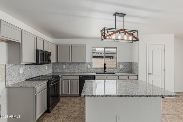 23637 N Desert Dr, Florence, AZ 85132 - kitchen with black appliances, gray cabinetry, a sink, and light stone counters