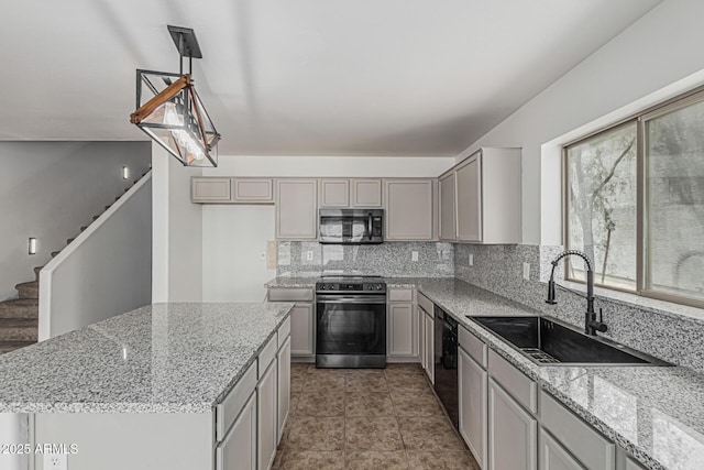 23637 N Desert Dr, Florence, AZ 85132 - kitchen with electric range oven, stainless steel microwave, a sink, gray cabinets, and decorative backsplash