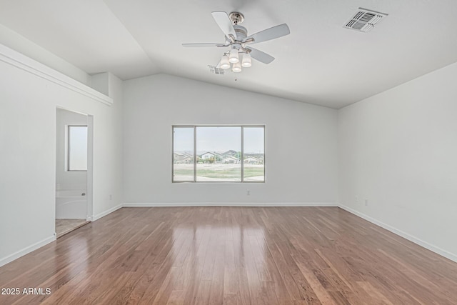 23637 N Desert Dr, Florence, AZ 85132 - spare room featuring wood finished floors, vaulted ceiling, ceiling fan, and baseboards