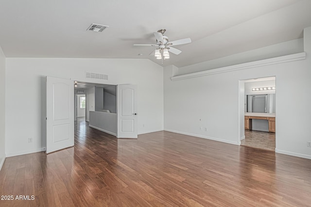 23637 N Desert Dr, Florence, AZ 85132 - spare room featuring a ceiling fan, vaulted ceiling, wood finished floors, and baseboards
