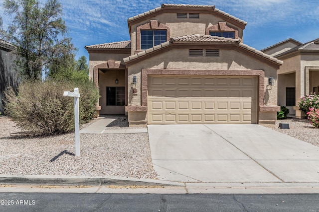 23637 N Desert Dr, Florence, AZ 85132 - mediterranean / spanish-style home featuring driveway, an attached garage, stucco siding, and a tiled roof