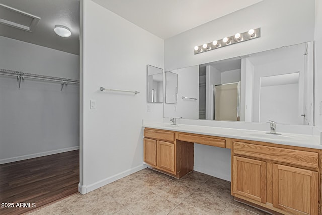 23637 N Desert Dr, Florence, AZ 85132 - bathroom with a shower stall, double vanity, a spacious closet, baseboards, and tile patterned floors