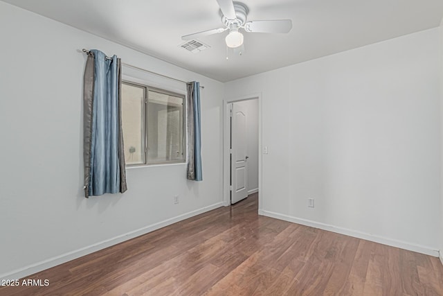 23637 N Desert Dr, Florence, AZ 85132 - empty room with wood finished floors, ceiling fan, and baseboards