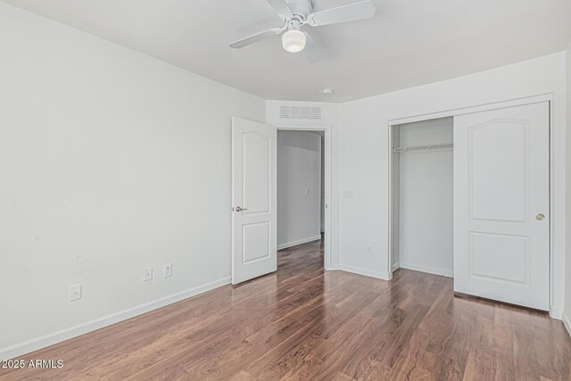 23637 N Desert Dr, Florence, AZ 85132 - unfurnished bedroom with wood finished floors, baseboards, a closet, and ceiling fan