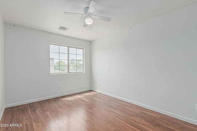 23637 N Desert Dr, Florence, AZ 85132 - unfurnished room with wood finished floors, a ceiling fan, and baseboards