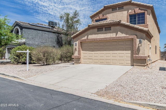 23637 N Desert Dr, Florence, AZ 85132 - view of front facade with concrete driveway, a tile roof, stucco siding, and central air condition unit