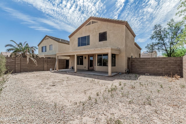 23637 N Desert Dr, Florence, AZ 85132 - back of property with stucco siding, a patio area, and a fenced backyard