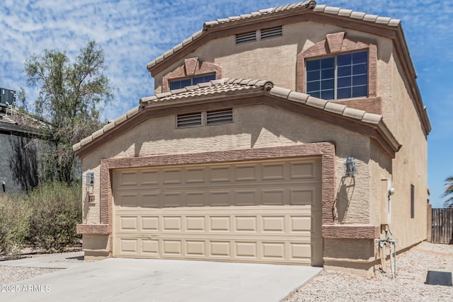 23637 N Desert Dr, Florence, AZ 85132 - view of front of home featuring driveway, a tile roof, stucco siding, and an attached garage
