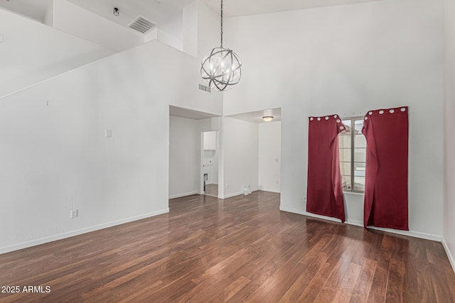 23637 N Desert Dr, Florence, AZ 85132 - empty room with a chandelier, wood finished floors, a high ceiling, and baseboards