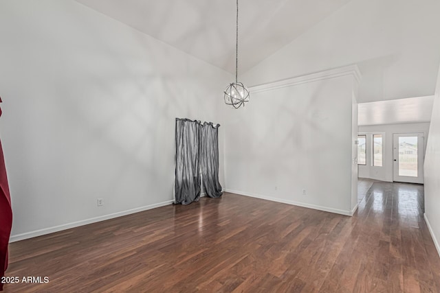 23637 N Desert Dr, Florence, AZ 85132 - unfurnished dining area featuring dark wood finished floors, a chandelier, baseboards, and high vaulted ceiling
