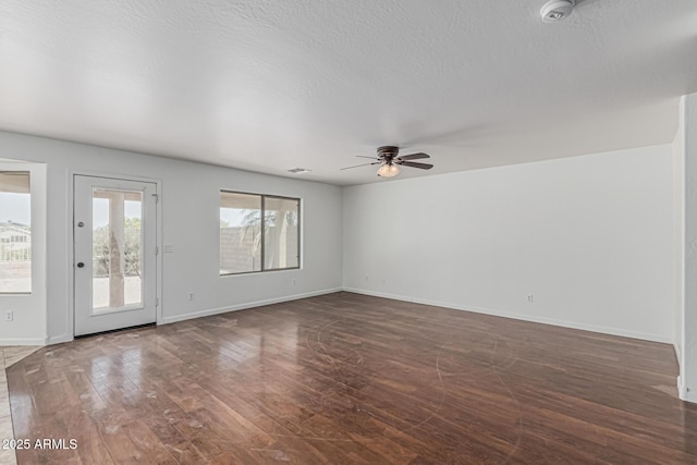 23637 N Desert Dr, Florence, AZ 85132 - empty room featuring ceiling fan, wood finished floors, a smoke detector, baseboards, and a textured ceiling