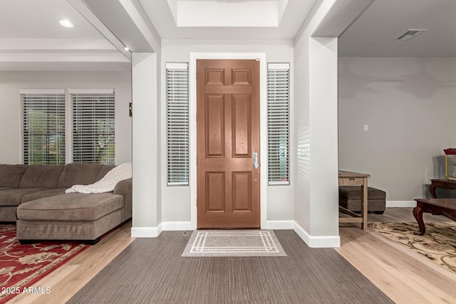 3331 N Acacia Way, Buckeye, AZ 85396 - foyer entrance featuring wood finished floors, baseboards, a tray ceiling, and recessed lighting