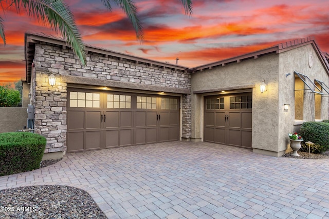 28247 N 128th Dr, Peoria, AZ 85383 - garage at dusk with decorative driveway