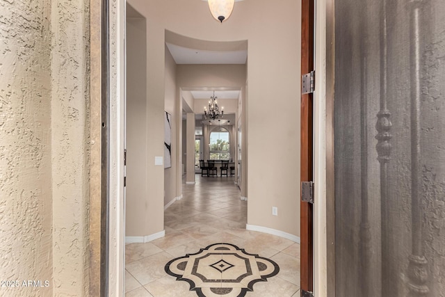 28247 N 128th Dr, Peoria, AZ 85383 - corridor with a notable chandelier, baseboards, and light tile patterned floors