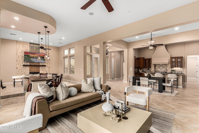 28247 N 128th Dr, Peoria, AZ 85383 - living area with a large fireplace, a ceiling fan, and recessed lighting