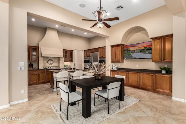 28247 N 128th Dr, Peoria, AZ 85383 - dining space with ceiling fan, a towering ceiling, visible vents, baseboards, and washer / dryer