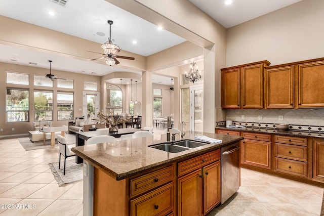 28247 N 128th Dr, Peoria, AZ 85383 - kitchen featuring tasteful backsplash, a kitchen island with sink, brown cabinetry, and a sink